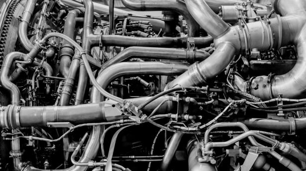A General Electric GE90 engine and its bleed air ducts at a Hong Kong Aircraft Engineering Co. (Haeco) hangar in Hong Kong, China, on Friday, March 21, 2025. Airlines are booking in their planes for maintenance years ahead of time in order to secure a slot as supply chain issues crimp the availability of crucial parts and servicing, the head of Haeco said. Photographer: Paul Yeung/Bloomberg