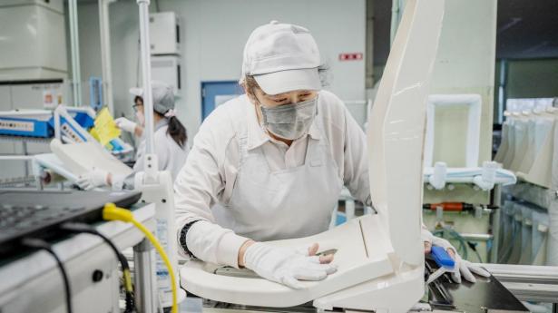 This picture taken on March 4, 2024 shows a worker at an assembly line of the Washlet Techno factory of Japanese toilet manufacturer TOTO in Toki city of Gifu prefecture. As Japan plays host to a record influx of tourists, one of the country's more private attractions -- the high-tech toilet -- is becoming a must-have in luxury bathrooms worldwide. Yuichi YAMAZAKI / AFP