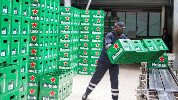 A worker arranges beer crates on a conveyor belt at the Heineken production plant at the Bralirwa Ltd, in Gisenyi, Rwanda January 18, 2019. REUTERS/Jean Bizimana
