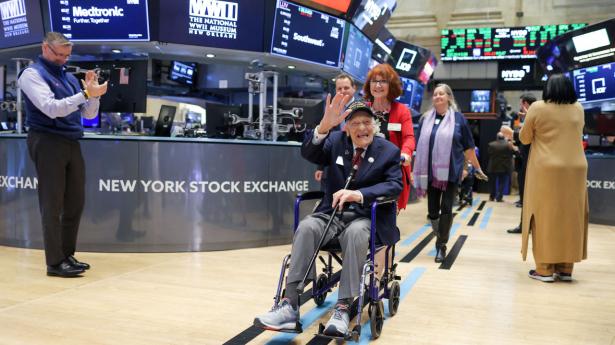 101 year old World War 2 Veteran Dominick Critelli, who served with the Army Air Corps 95th Infantry Division and featured in the Battle of the Bulge, is wheeled onto the trading floor by his daughter at the New York Stock Exchange (NYSE) on Veterans Day in Manhattan, New York City, U.S., November 11, 2022. REUTERS/Andrew Kelly