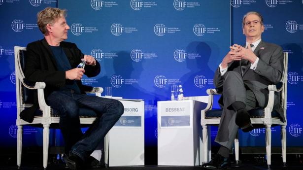 U.S. Treasury Secretary Scott Bessent speaks with Bjorn Lomborg during an event hosted by the Institute of International Finance