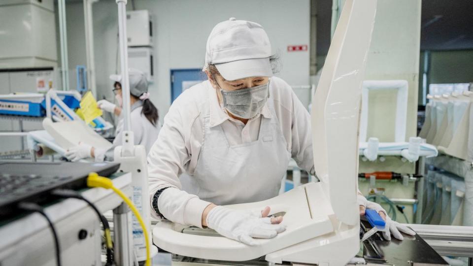 This picture taken on March 4, 2024 shows a worker at an assembly line of the Washlet Techno factory of Japanese toilet manufacturer TOTO in Toki city of Gifu prefecture. As Japan plays host to a record influx of tourists, one of the country's more private attractions -- the high-tech toilet -- is becoming a must-have in luxury bathrooms worldwide. Yuichi YAMAZAKI / AFP